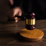 Brown wooden gavel on brown wooden table