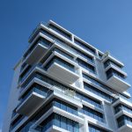 White concrete building under sunny blue sky