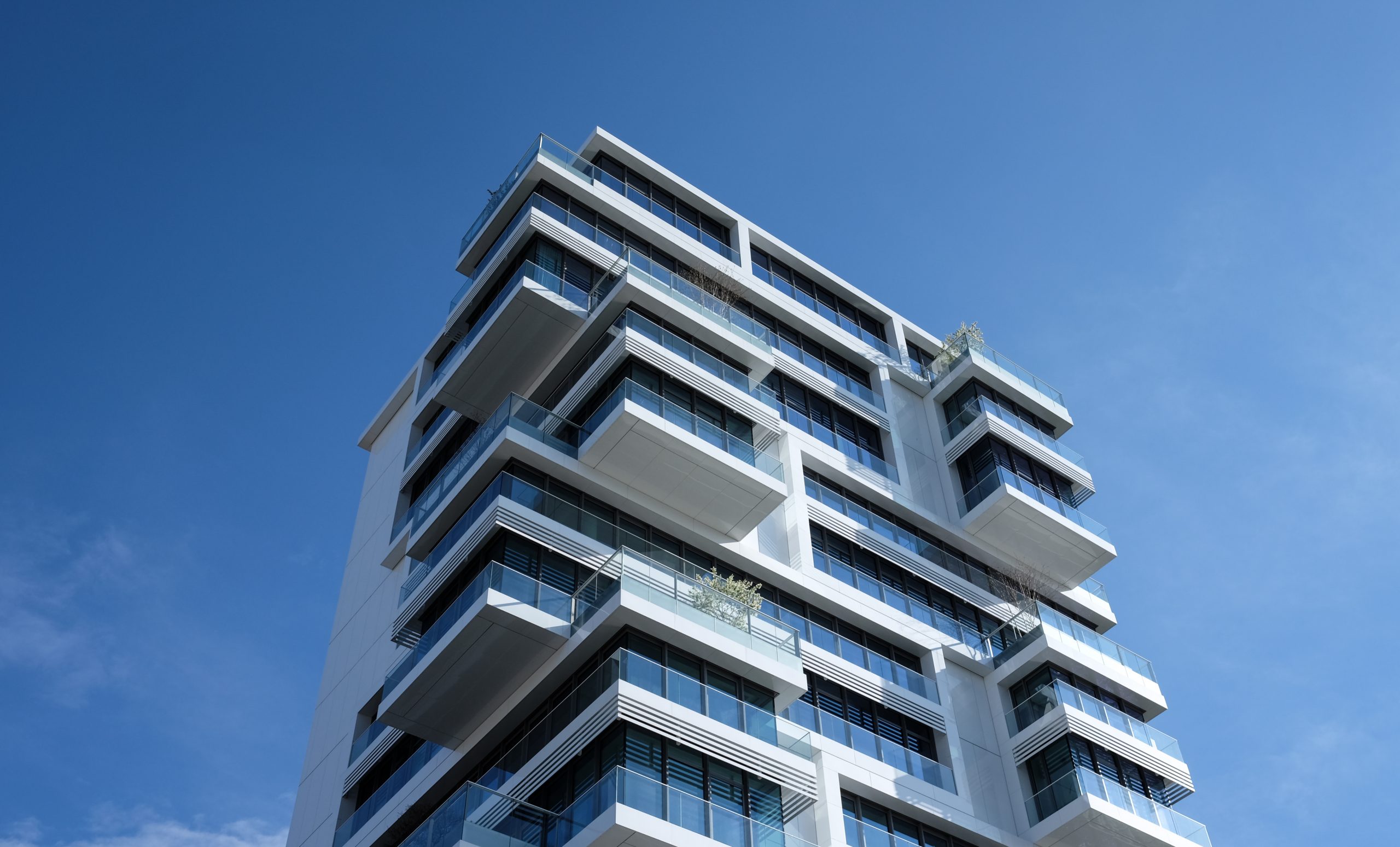 White concrete building under sunny blue sky