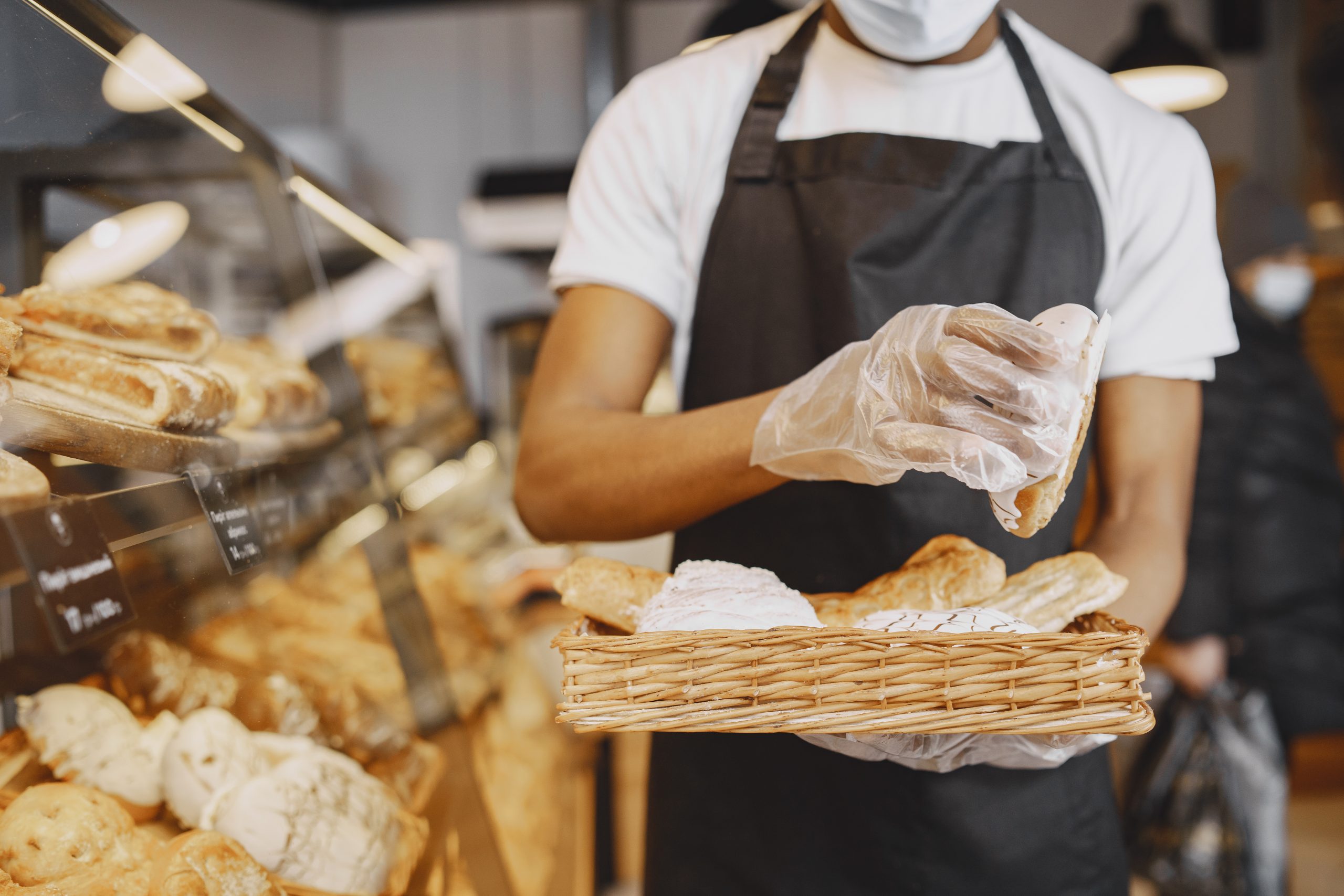 A person holding a tray of baked goods