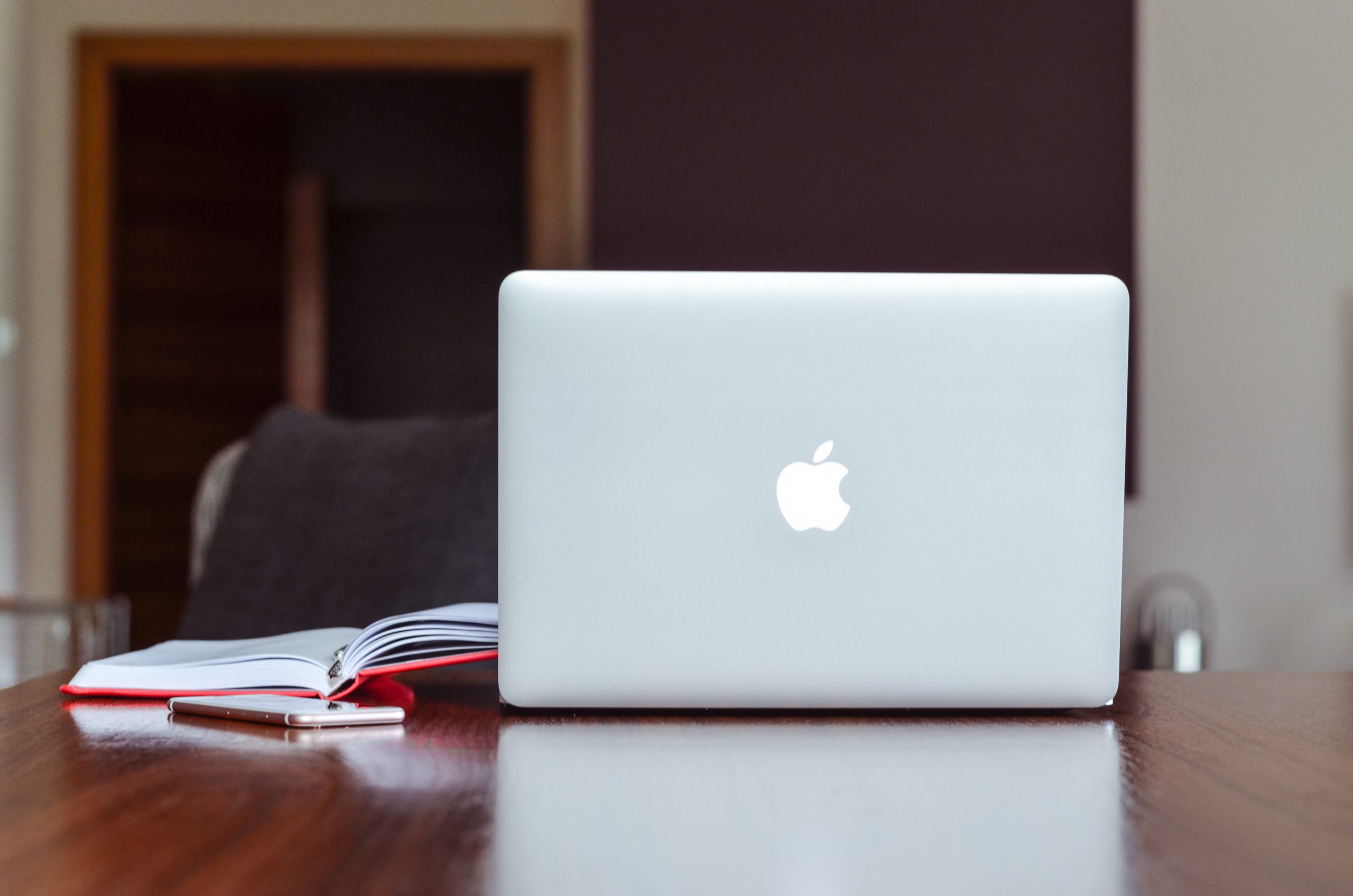 Macbook air near red book