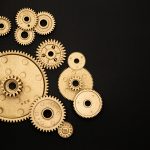 Photo of golden cogwheel on black background